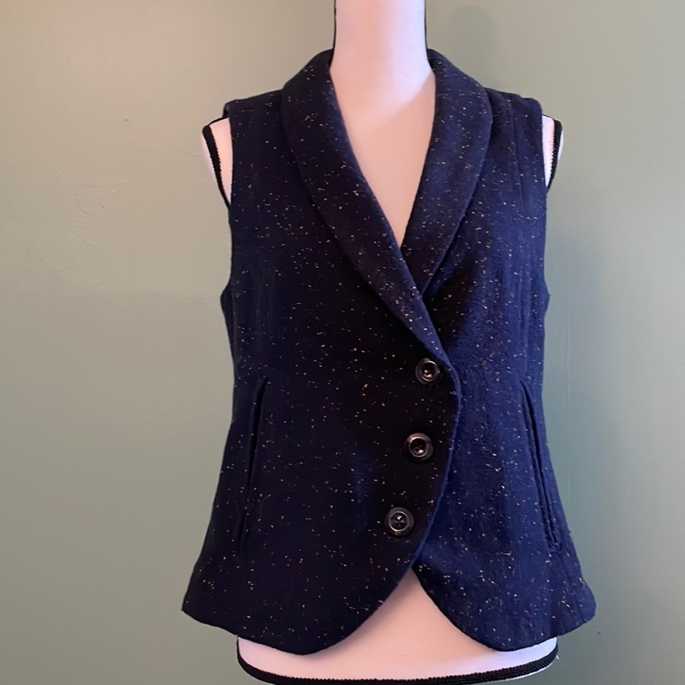 Navy blue vest with specks of yellow and red design.